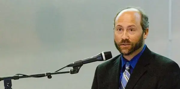 Dr. Nelson Jatel speaking at a podium, 2012